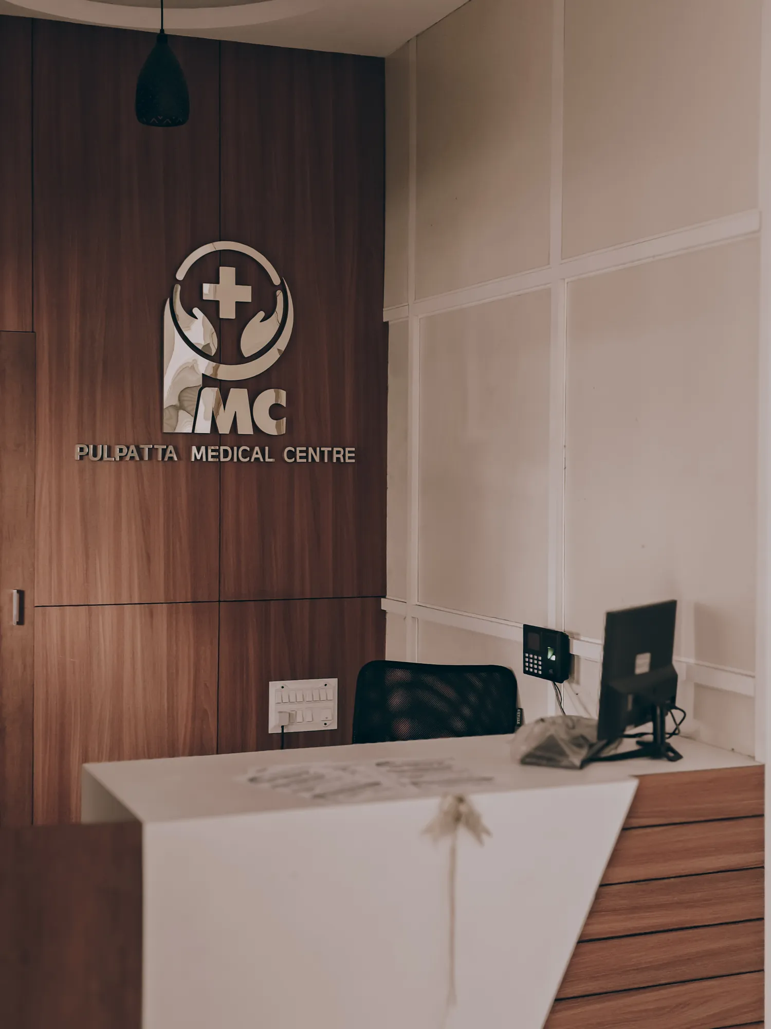 A modern hospital reception with warm wood panelling