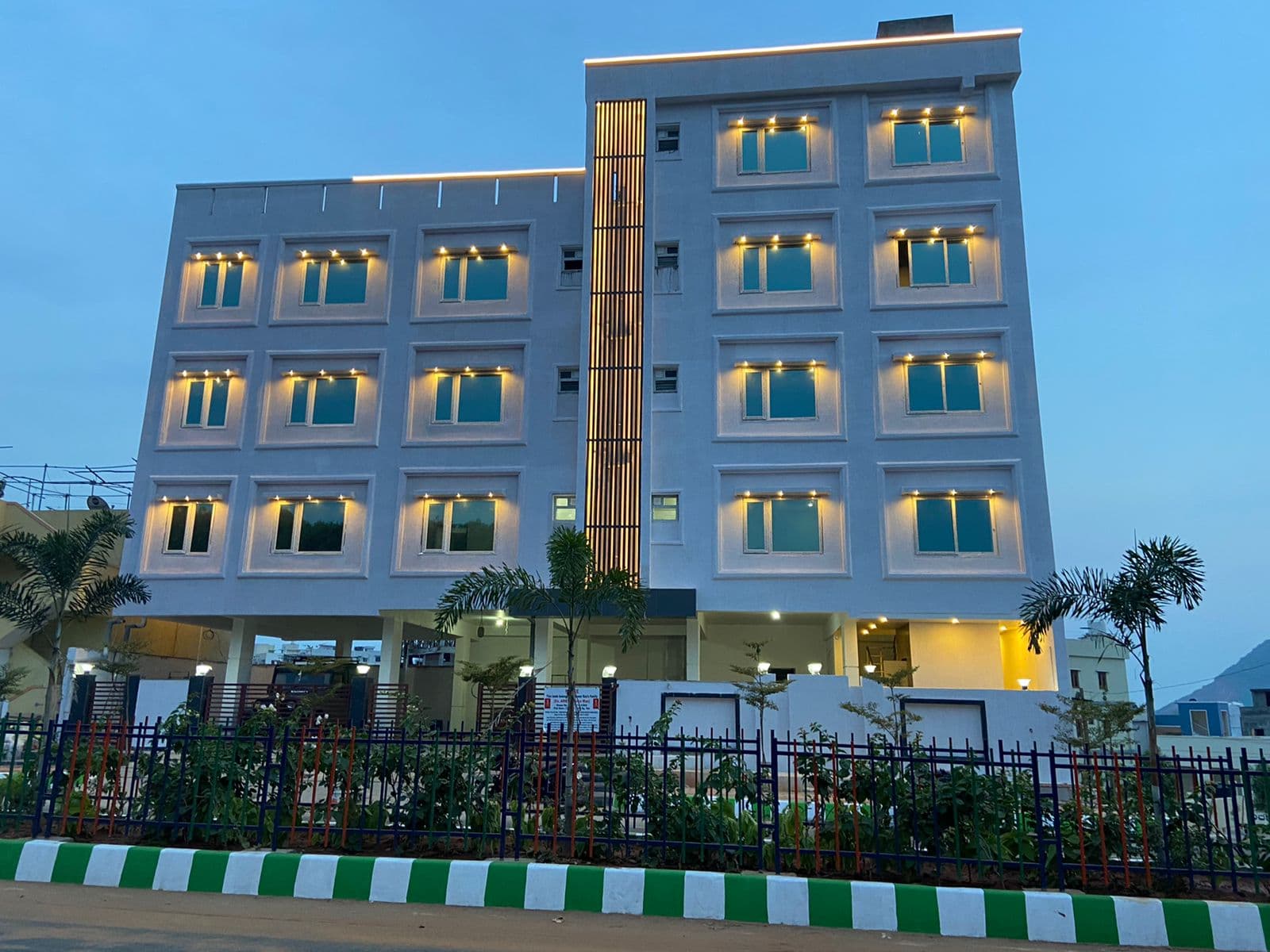 Aarogya Multispeciality Building lit at dusk
